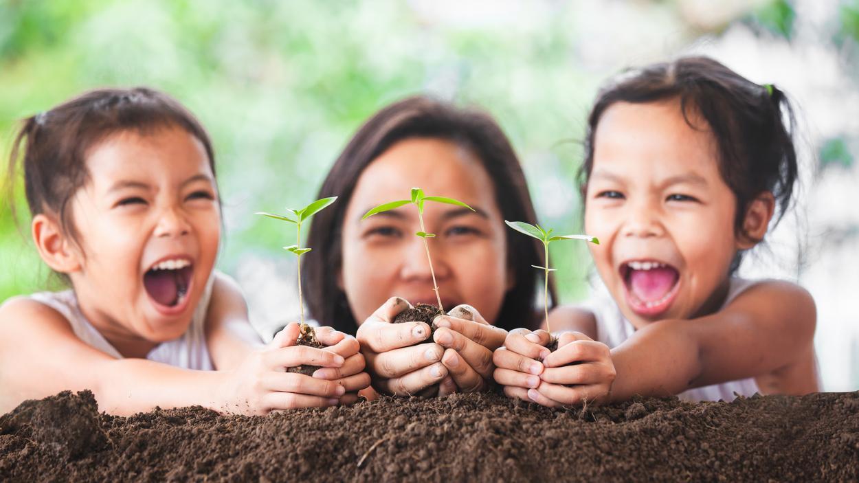 Children with plants. Photo credit: iStock/Sasiistock